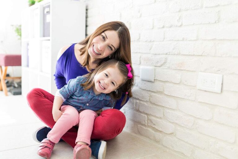 Mother and daughter smile at the pediatric dentist.